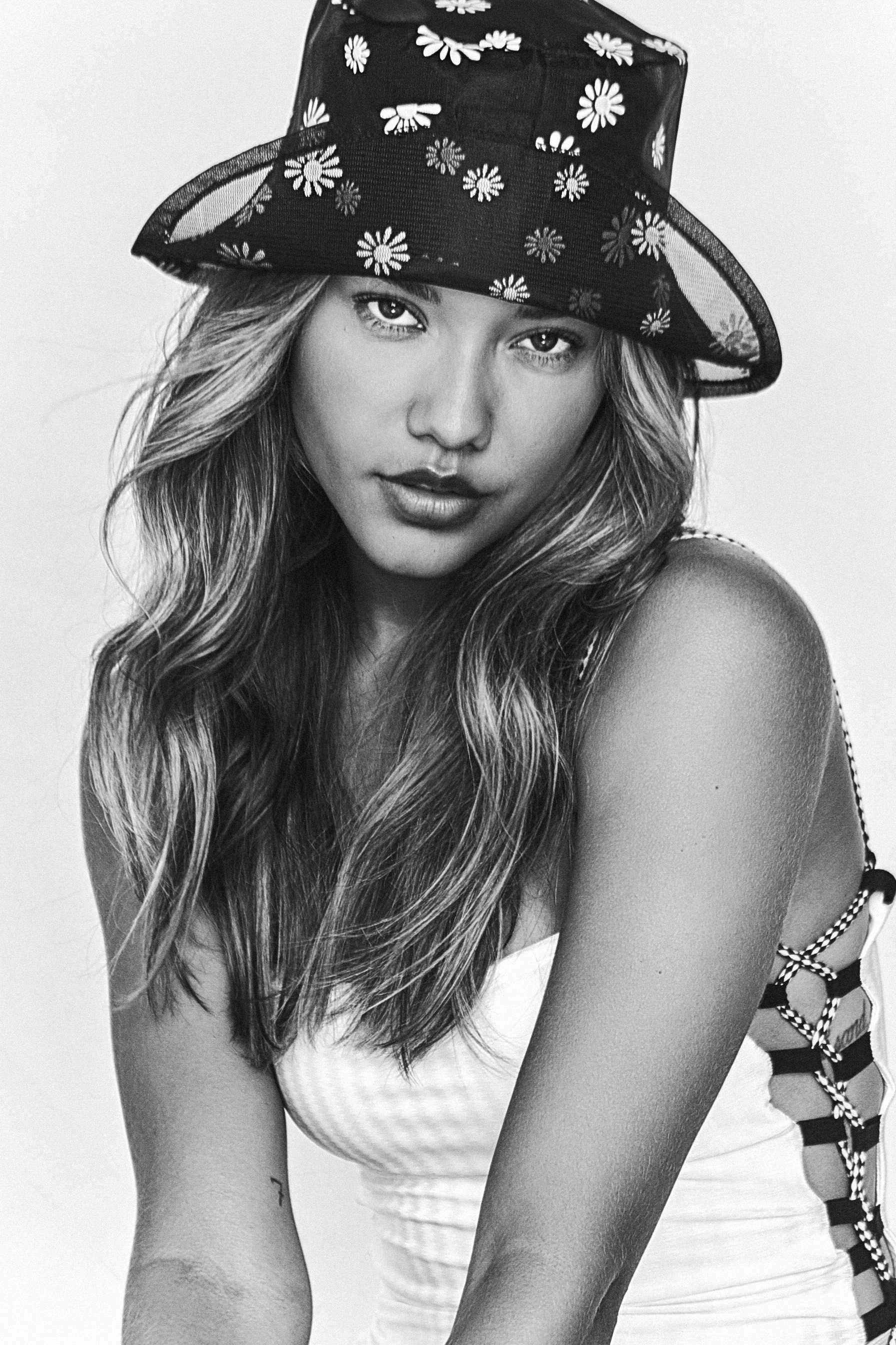 Foto em preto e branco de modelo usando chapéu bucket hat preto estampado com flores